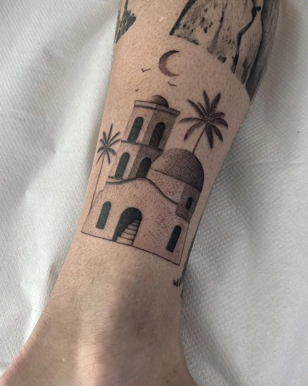 Artistic house tattoo with moon and palm trees