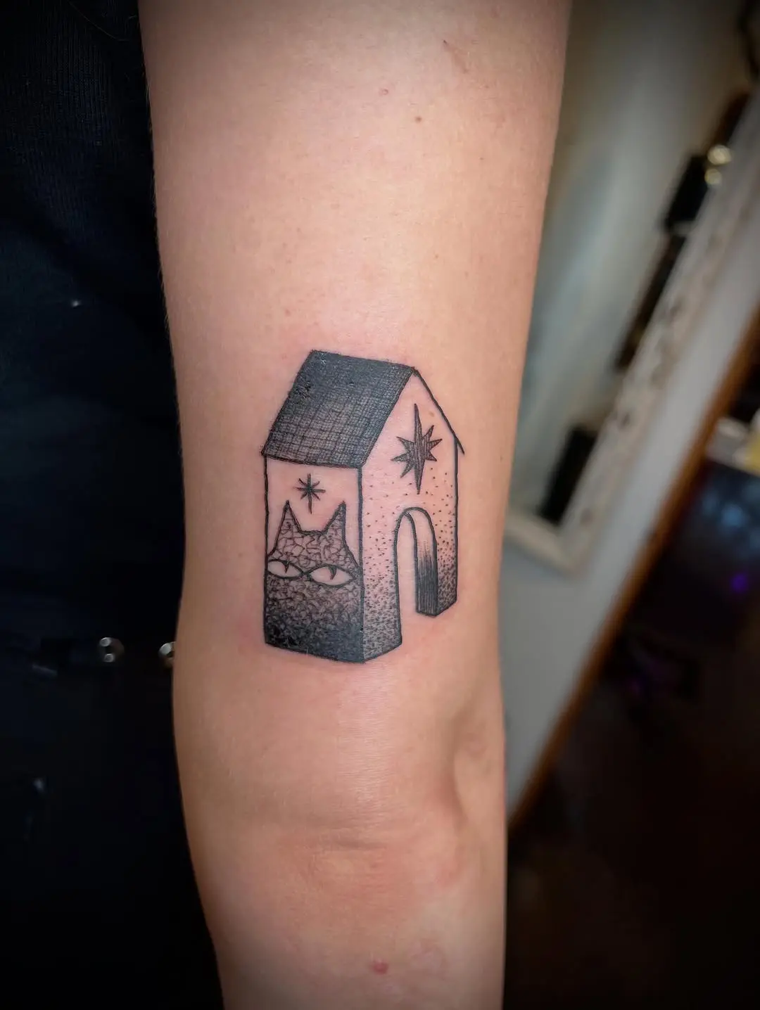Charming house tattoo with a playful twist