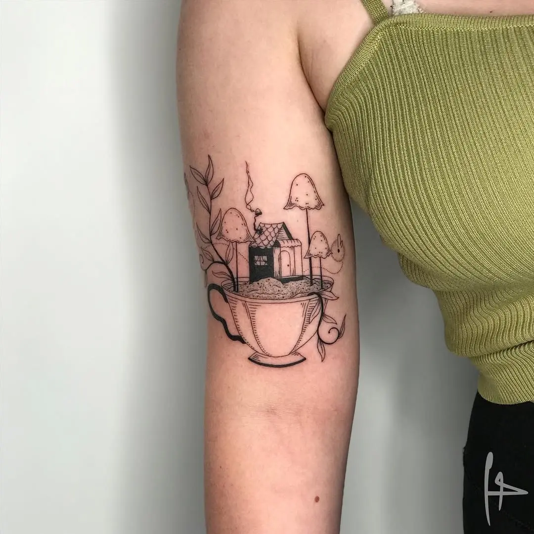 Charming house tattoo nestled in a cup
