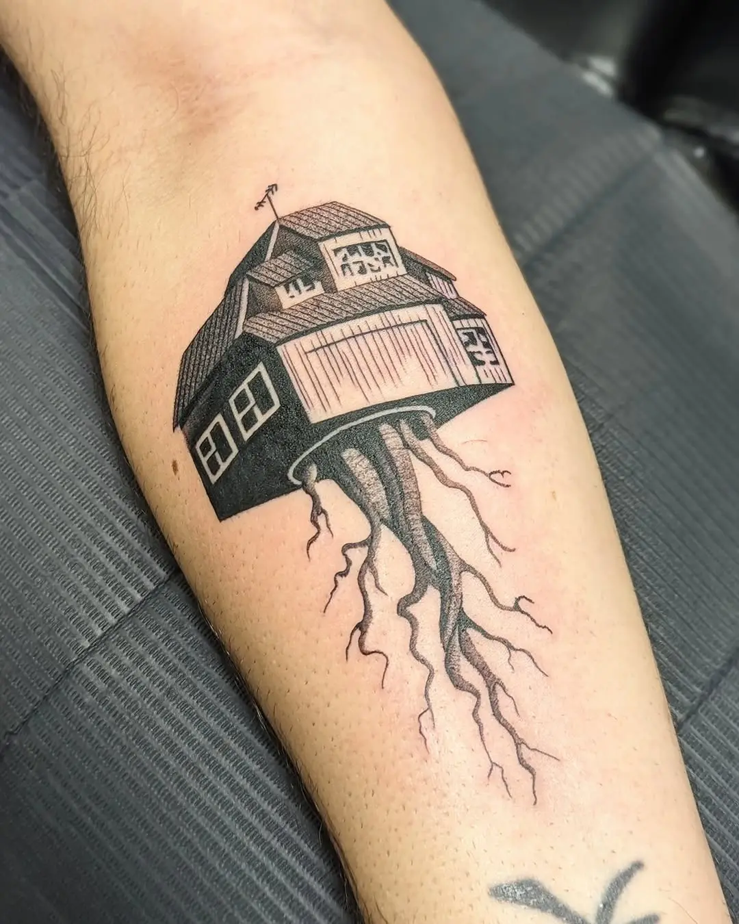 Unique house tattoo with striking roots design