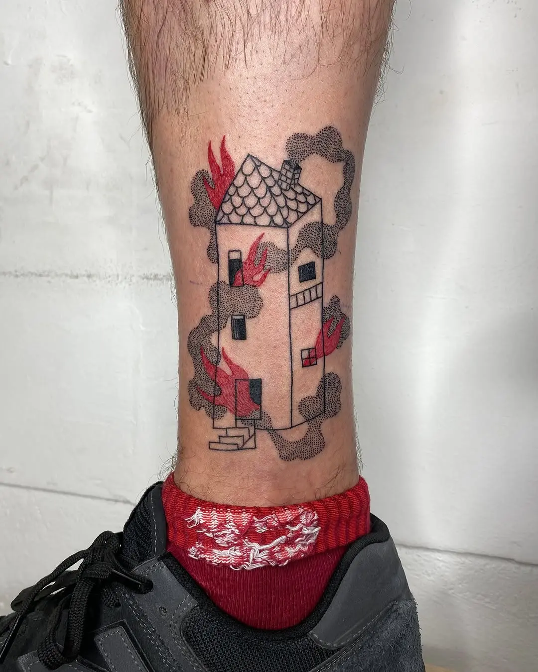 Whimsical house tattoo with fiery accents