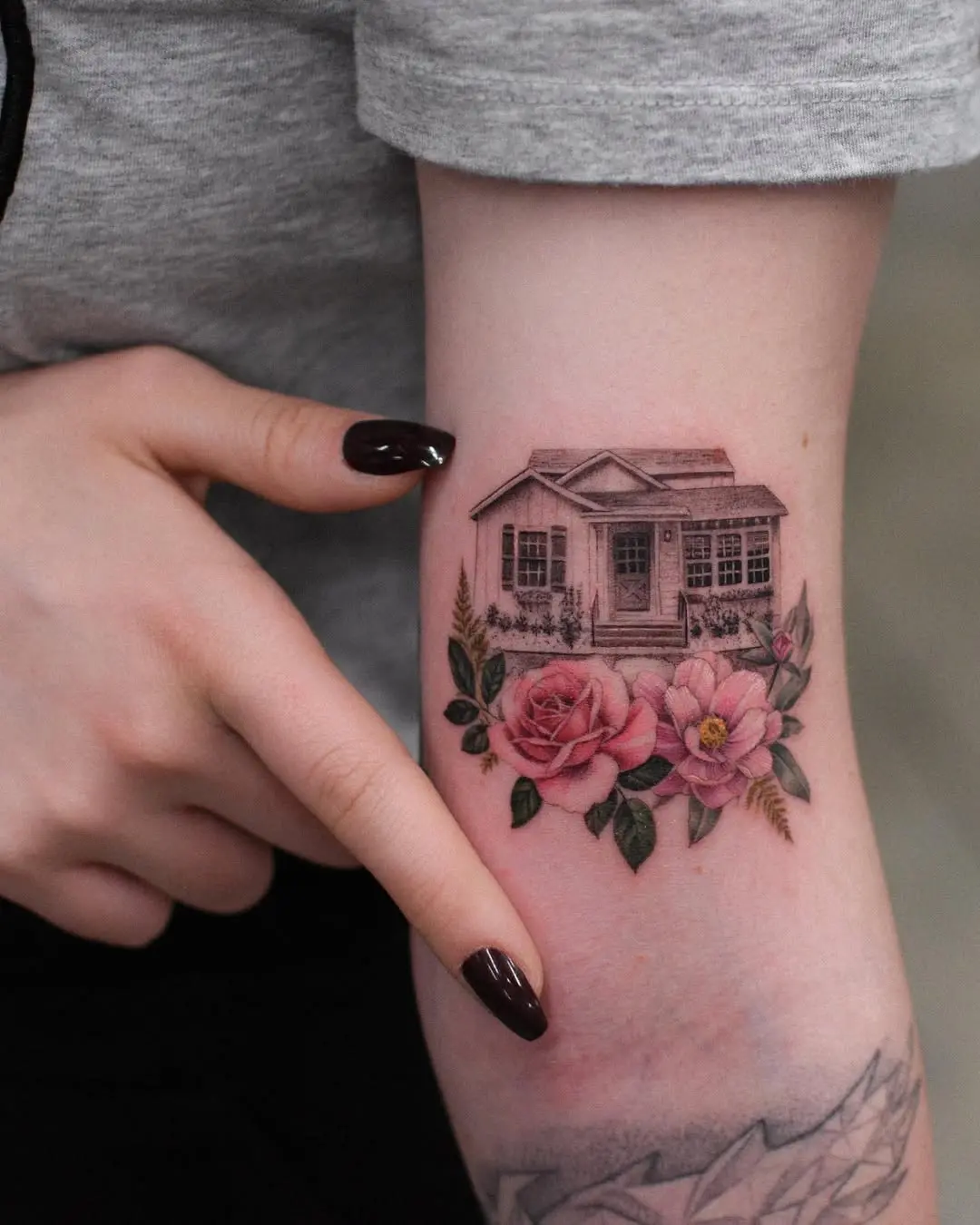 Charming house tattoo with floral accents