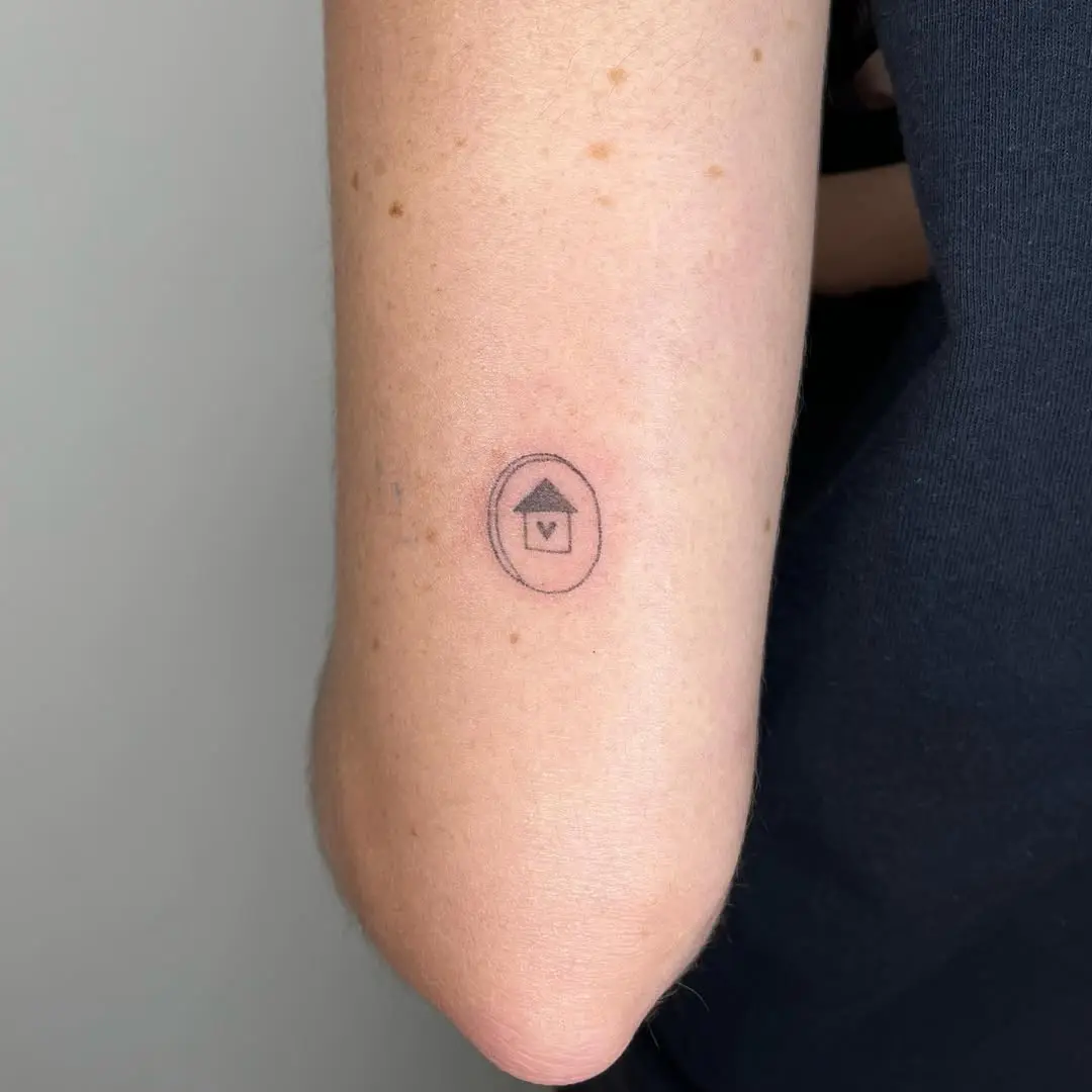 Charming minimalistic house outline tattoo