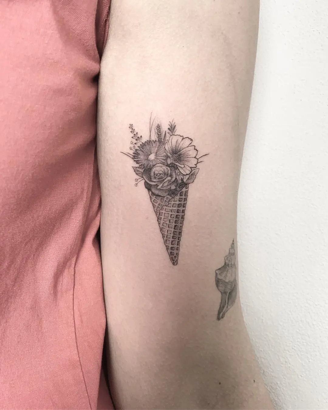 Floral cone tattoo with intricate detailing