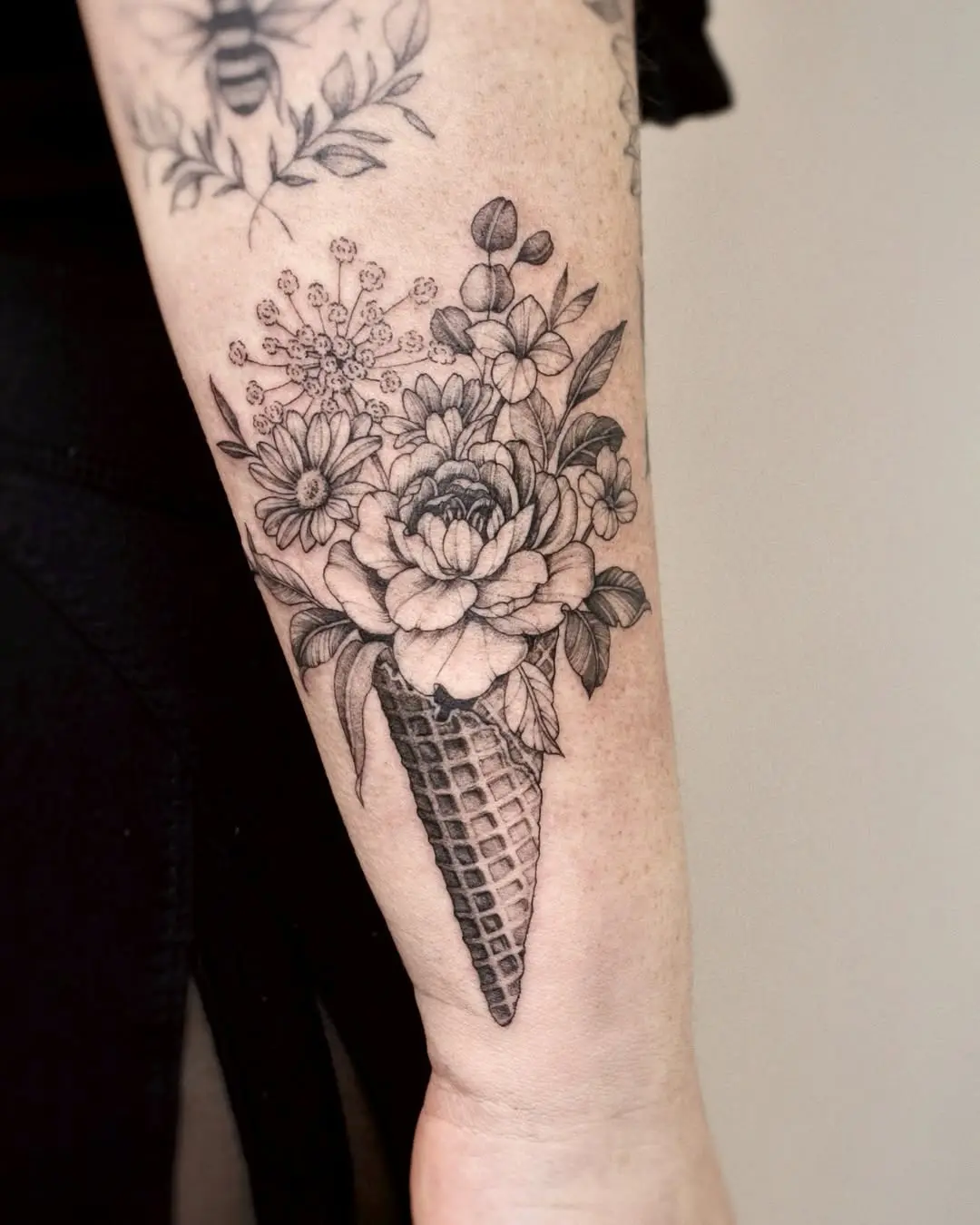 Blooming flowers in an ice cream cone tattoo