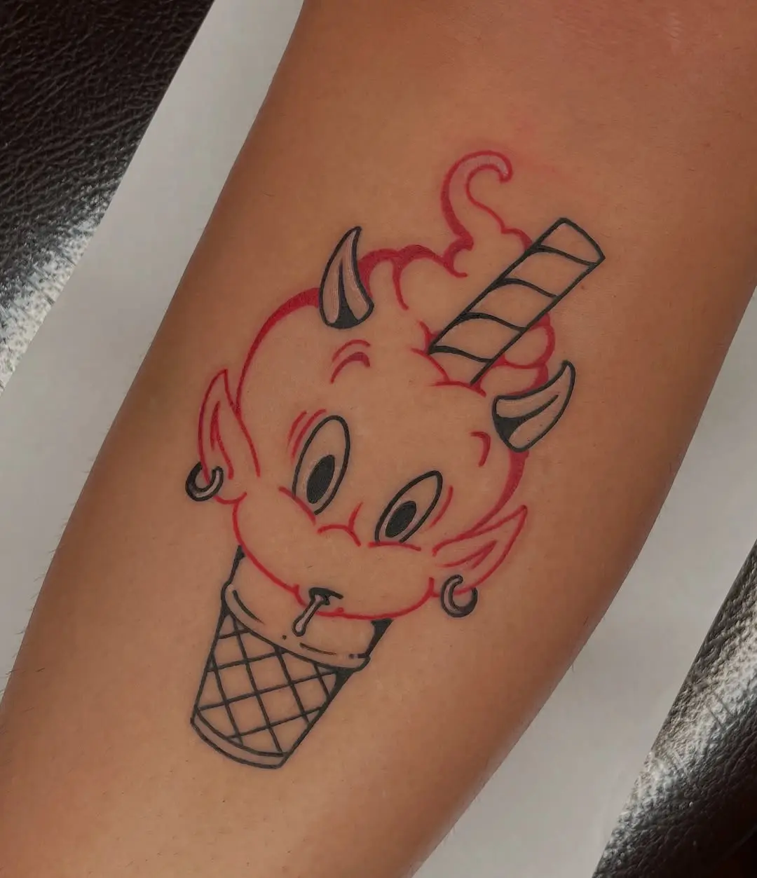 Playful devil-themed ice cream tattoo design