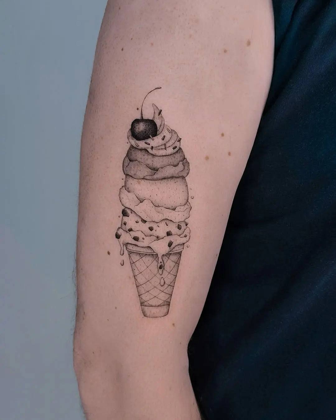 Charming ice cream cone tattoo with cherry
