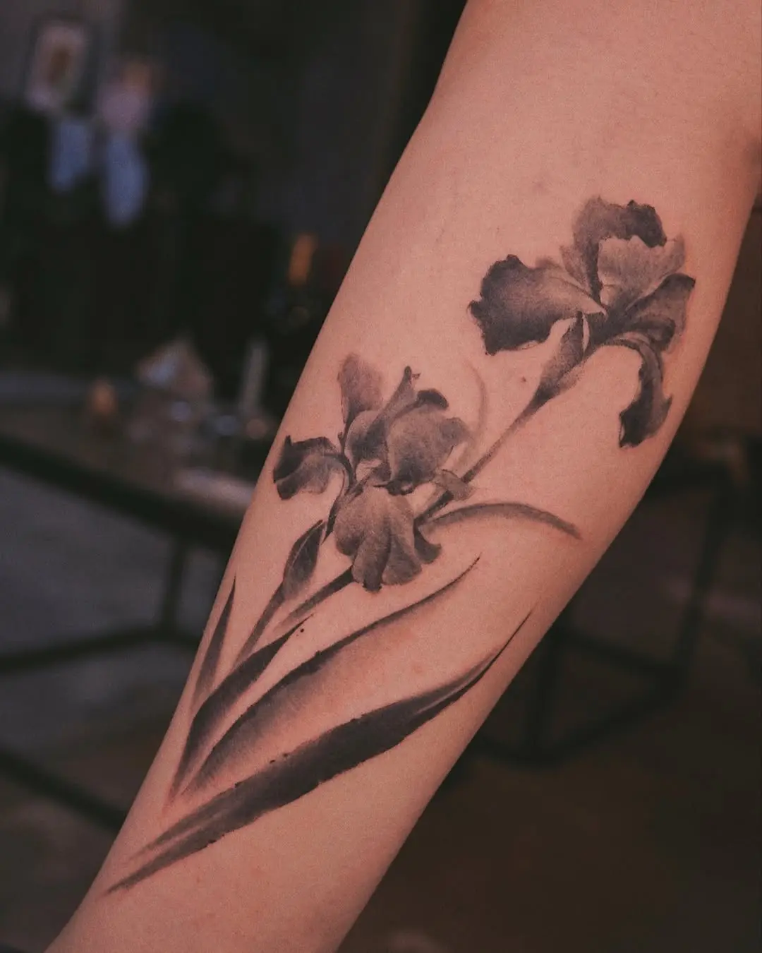 Elegant black and gray iris flower tattoo