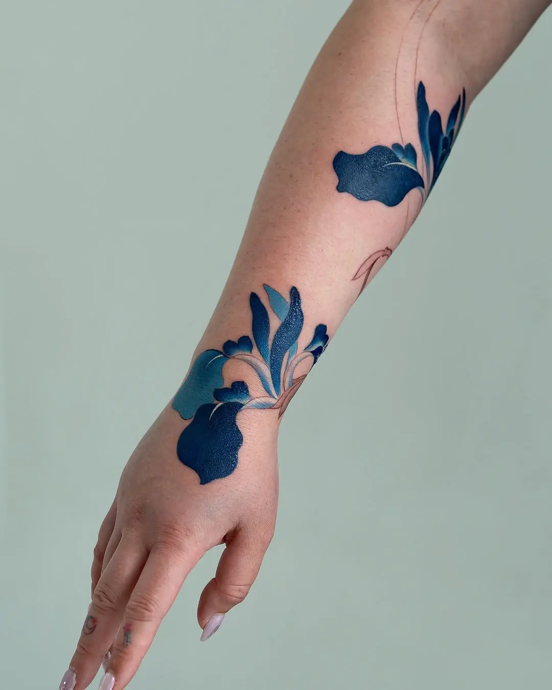 Elegant blue iris tattoo on the arm