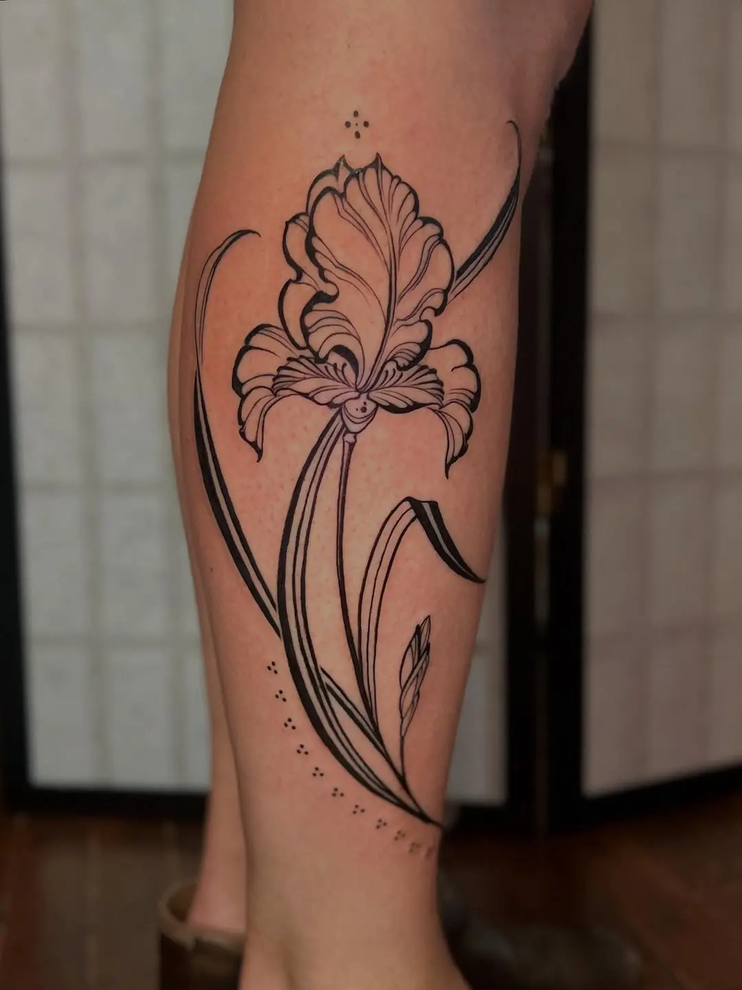 Intricate iris tattoo showcasing elegant linework