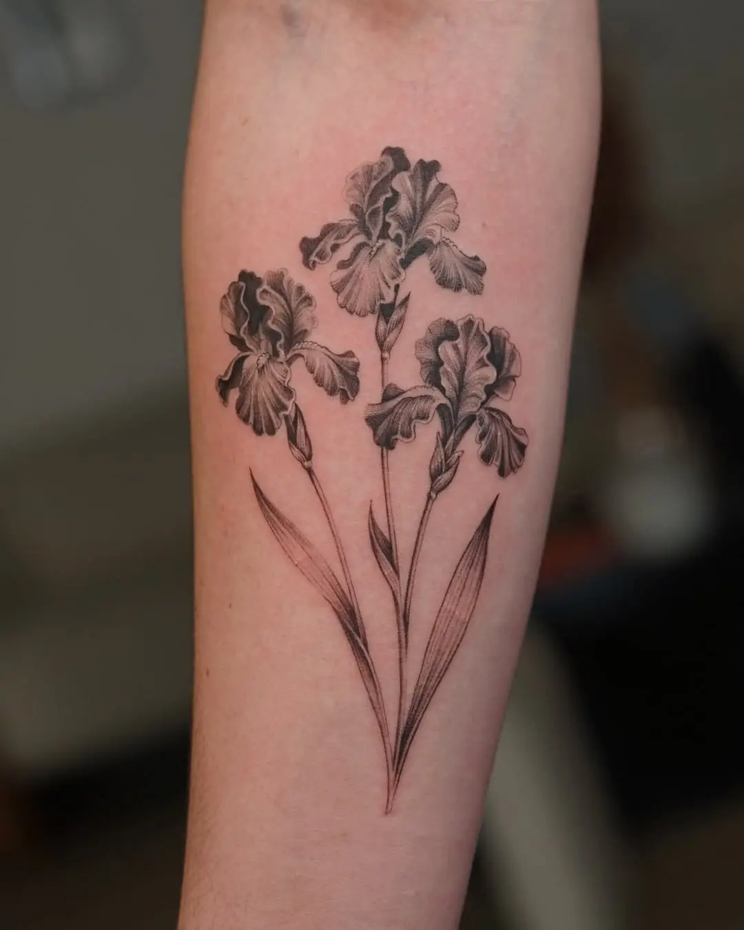 Elegant black ink iris flower tattoo design