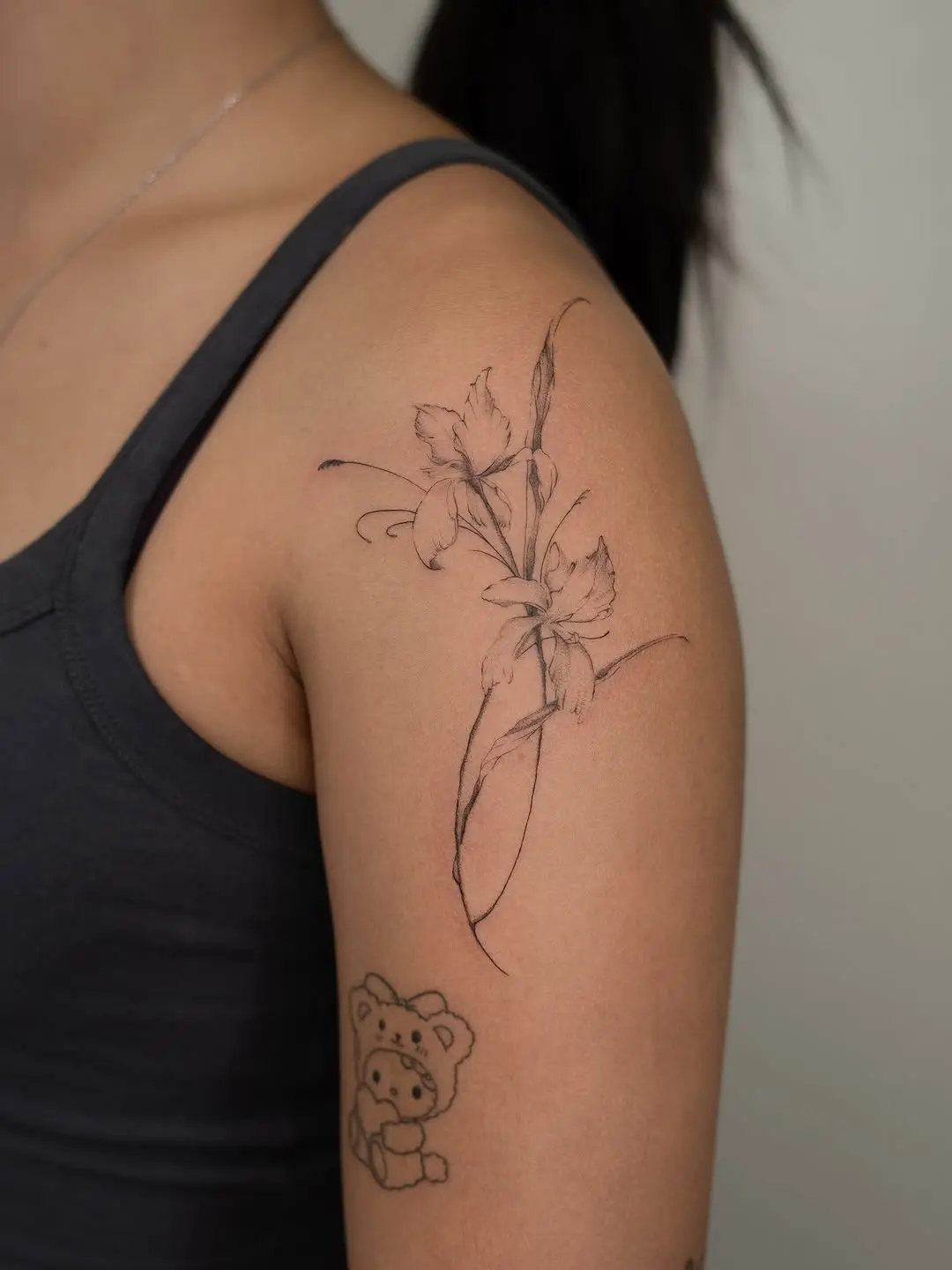 Elegant iris tattoo on upper arm