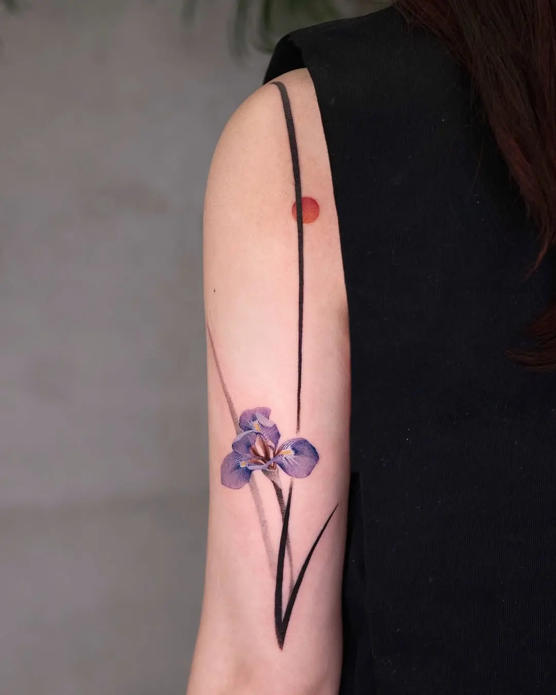 Stunning iris tattoo with elegant floral design