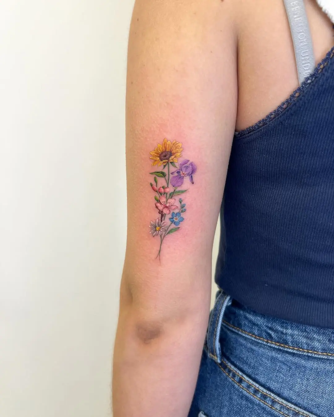 Elegant Iris Floral Tattoo on Upper Arm