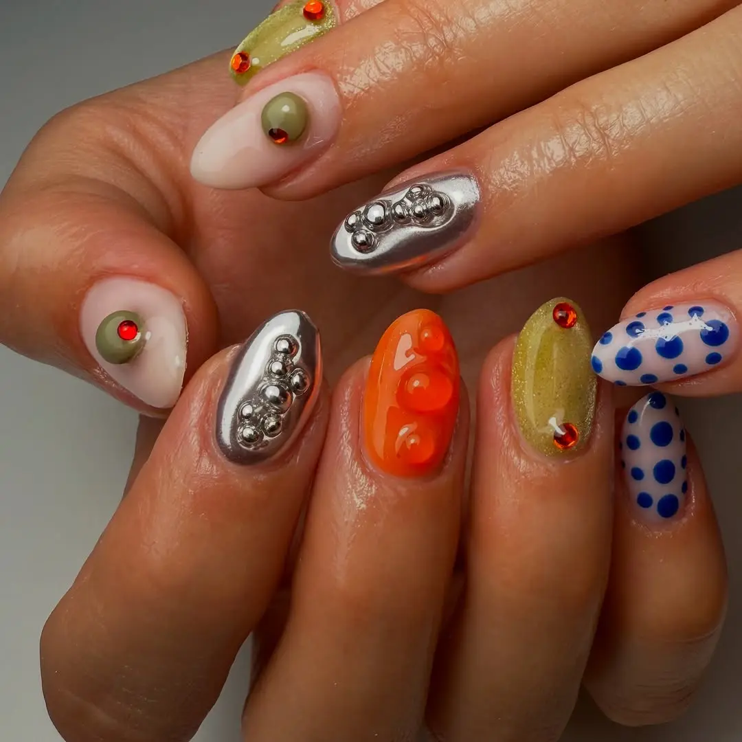 Playful artistic designs on vibrant Japanese nails.