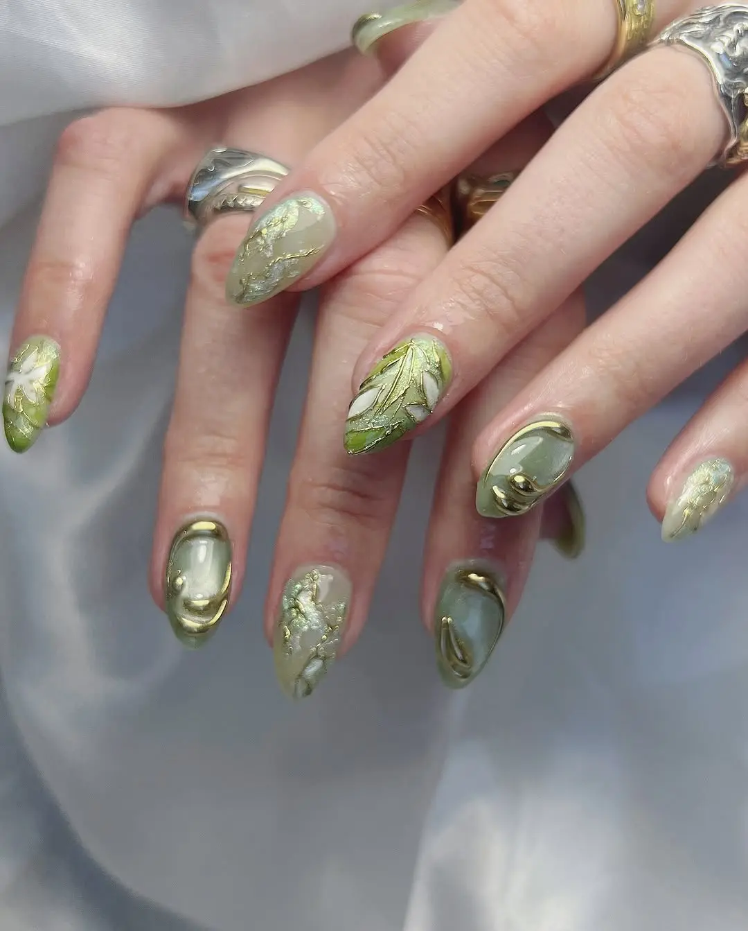 Elegant green floral nails with a gold touch