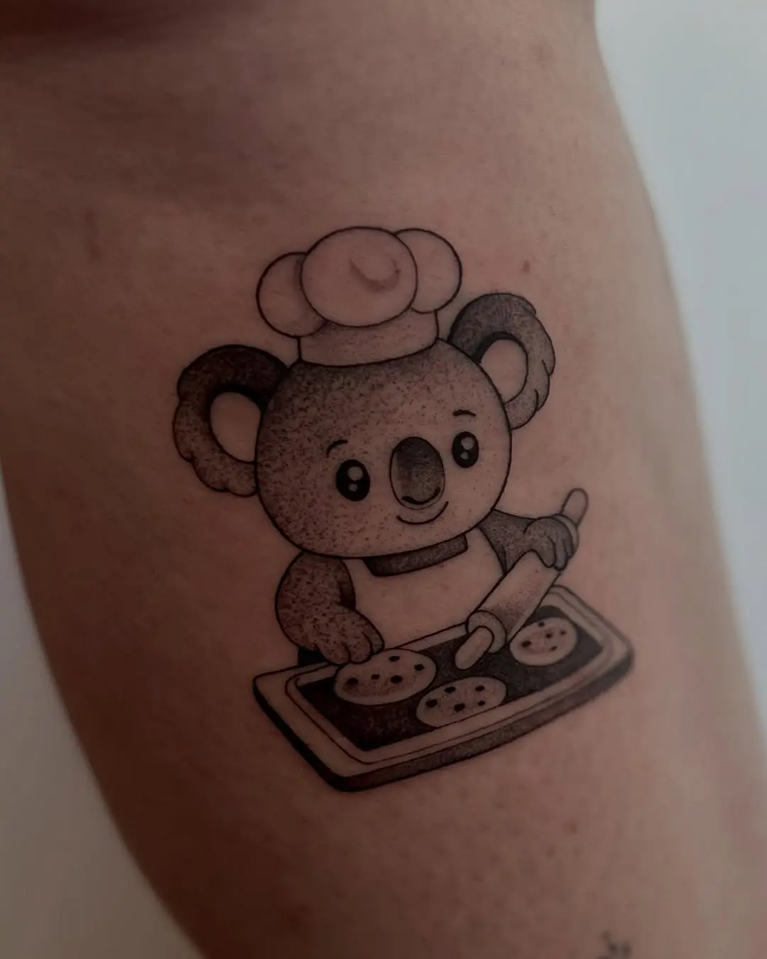 Adorable koala baking cookies tattoo