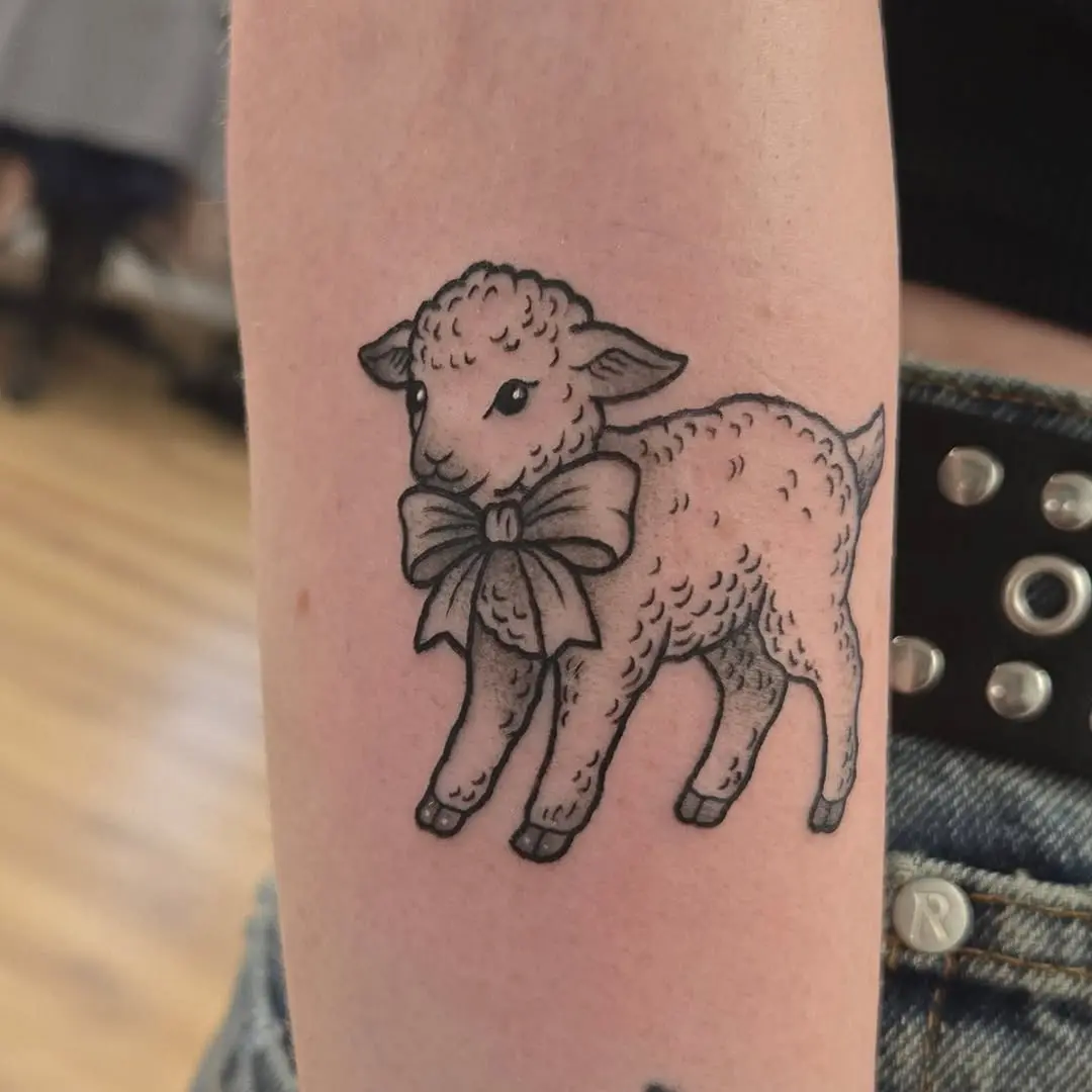 Adorable lamb tattoo with a sweet bow