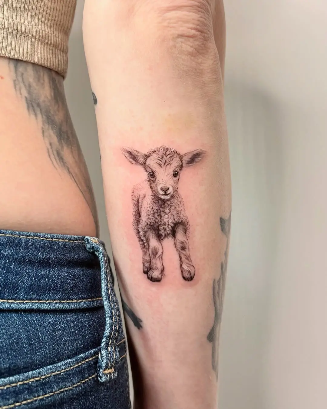 Whimsical lamb tattoo with playful energy