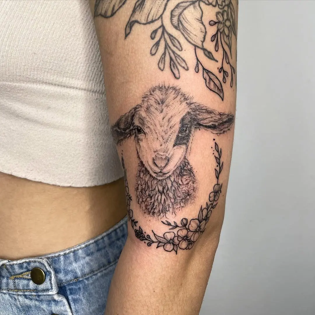 A Cute Lamb Tattoo Surrounded by Floral Elements
