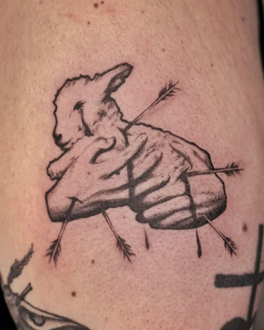 Intricate lamb tattoo with arrows piercing through