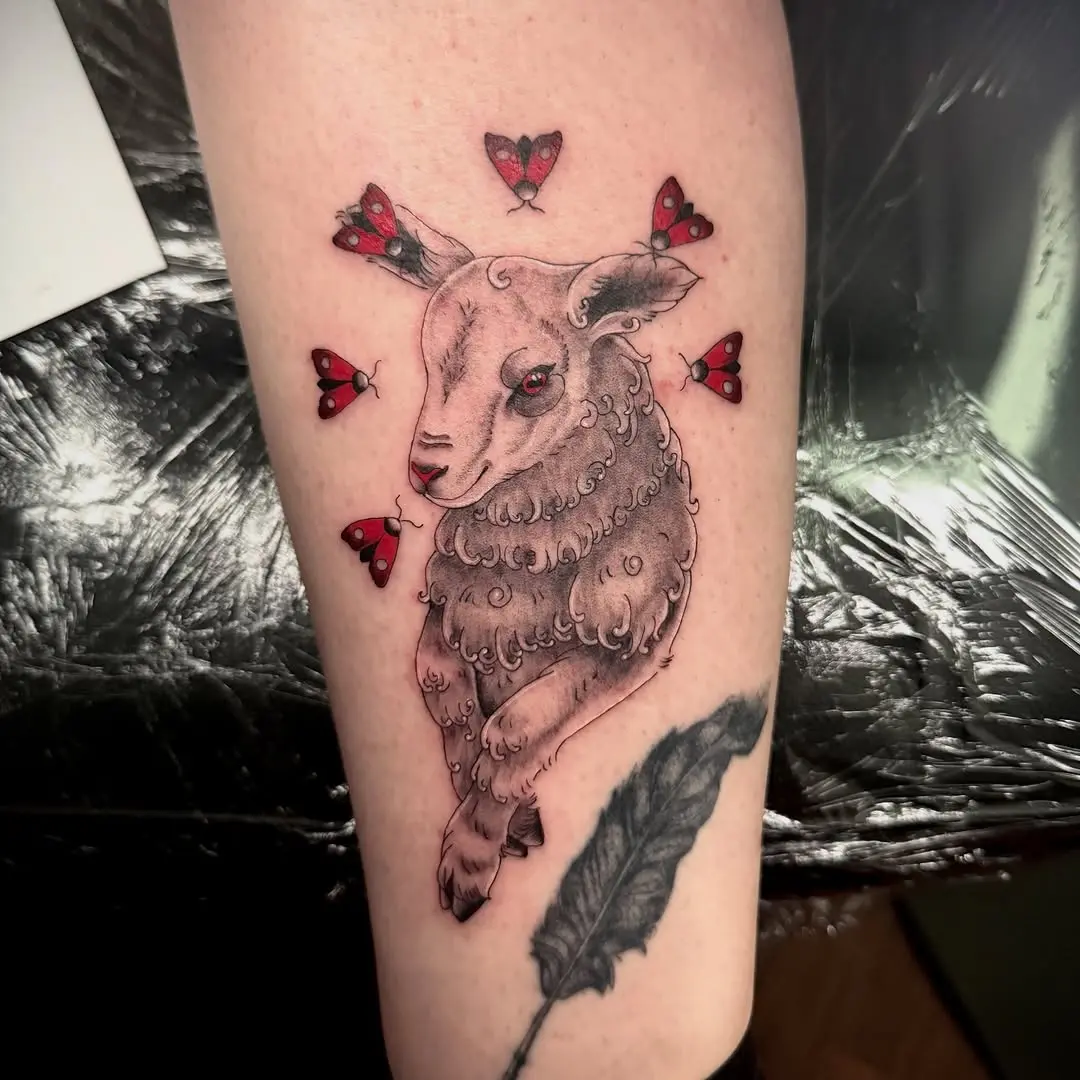 Whimsical lamb tattoo with butterfly accents