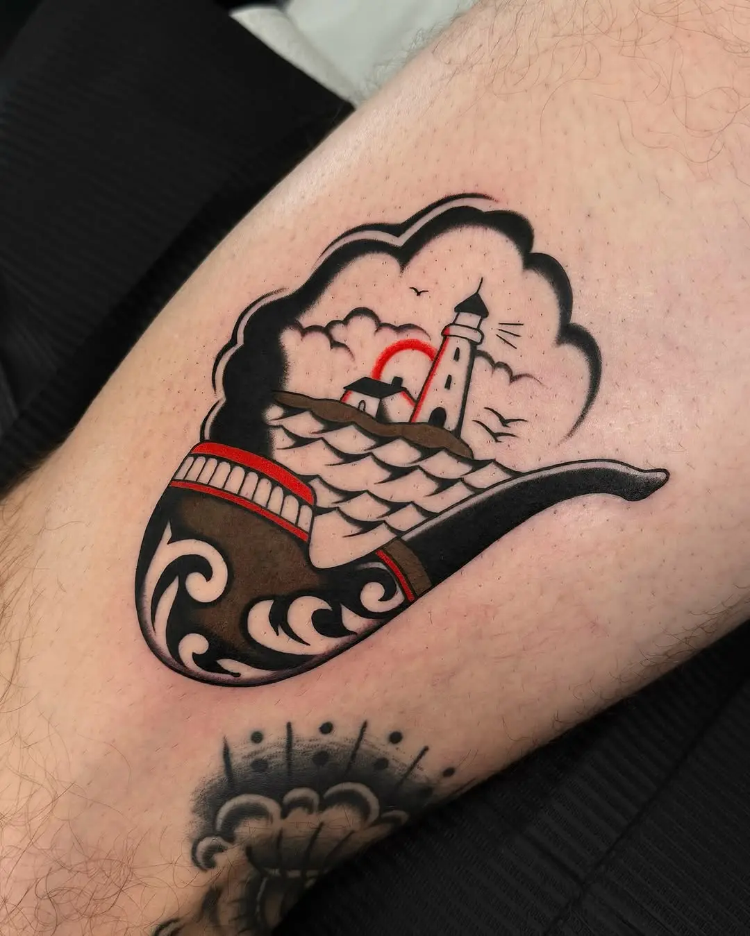 A unique lighthouse inside a smoking pipe tattoo