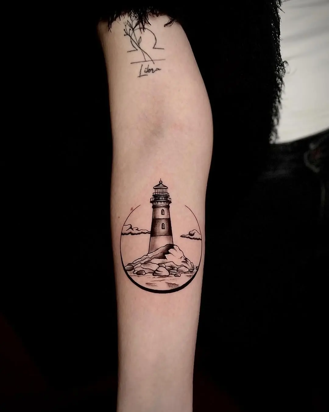 Elegant lighthouse tattoo symbolizing guidance and hope