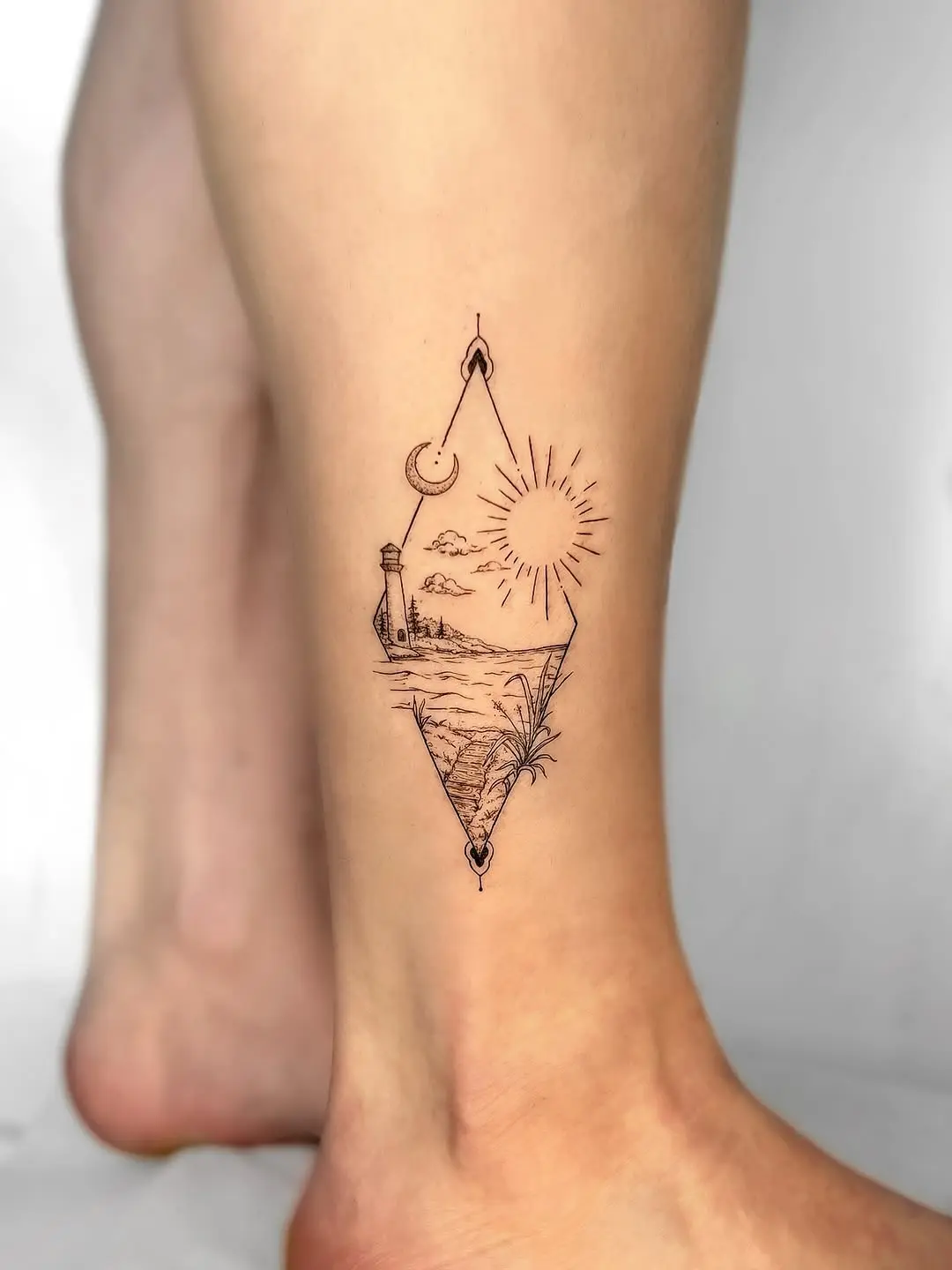 Intricate lighthouse tattoo with scenic elements