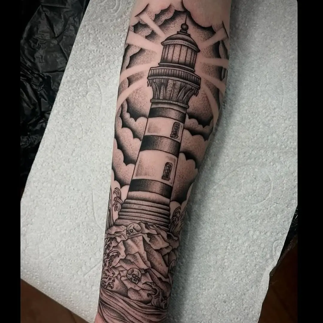 Detailed lighthouse tattoo with waves and clouds