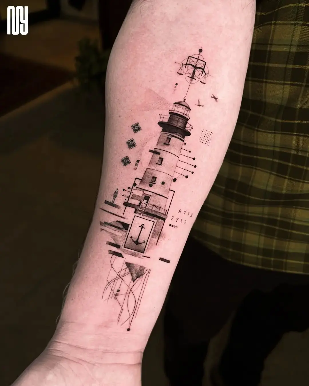 Stunning lighthouse tattoo with abstract elements