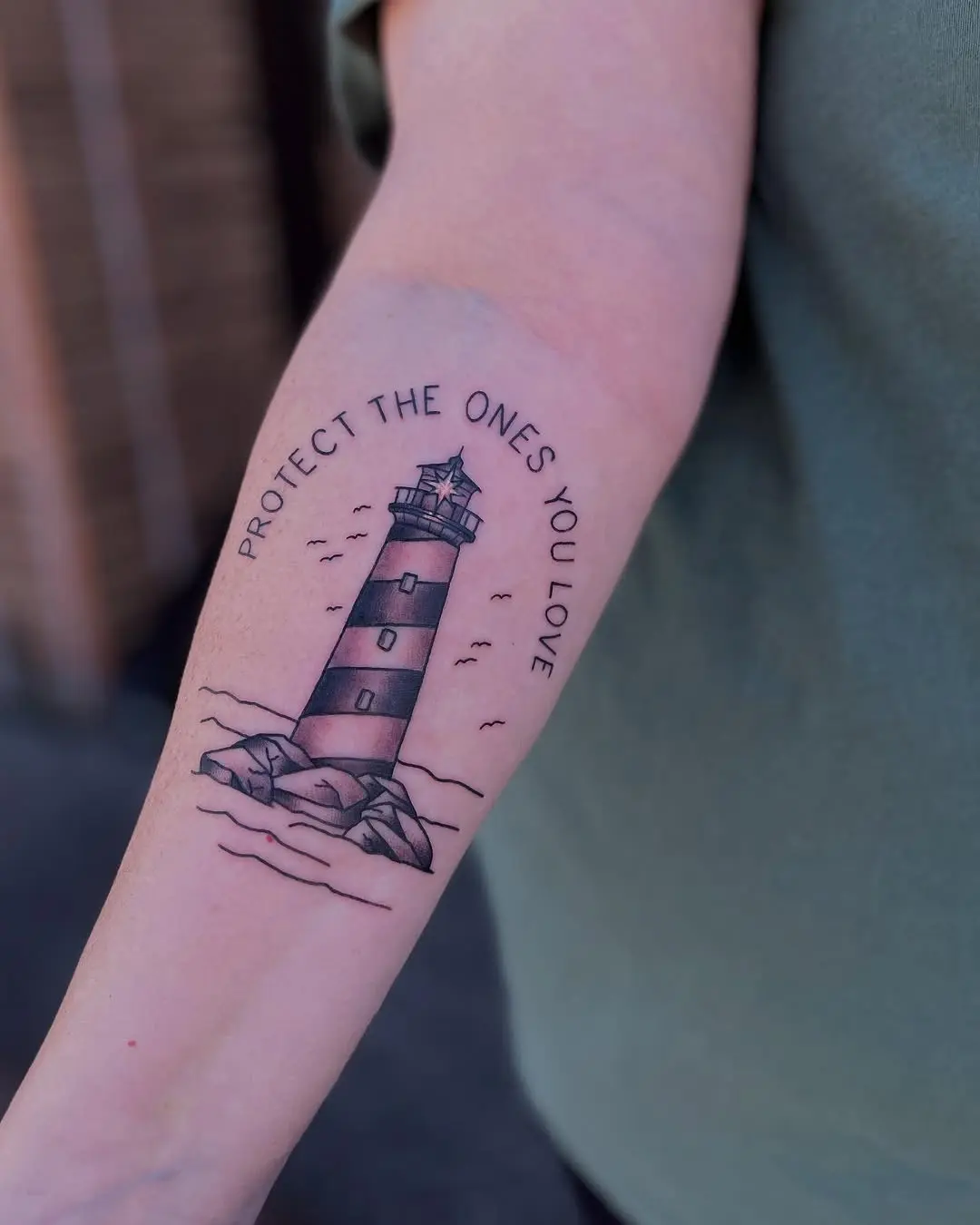 Meaningful lighthouse tattoo with protective message