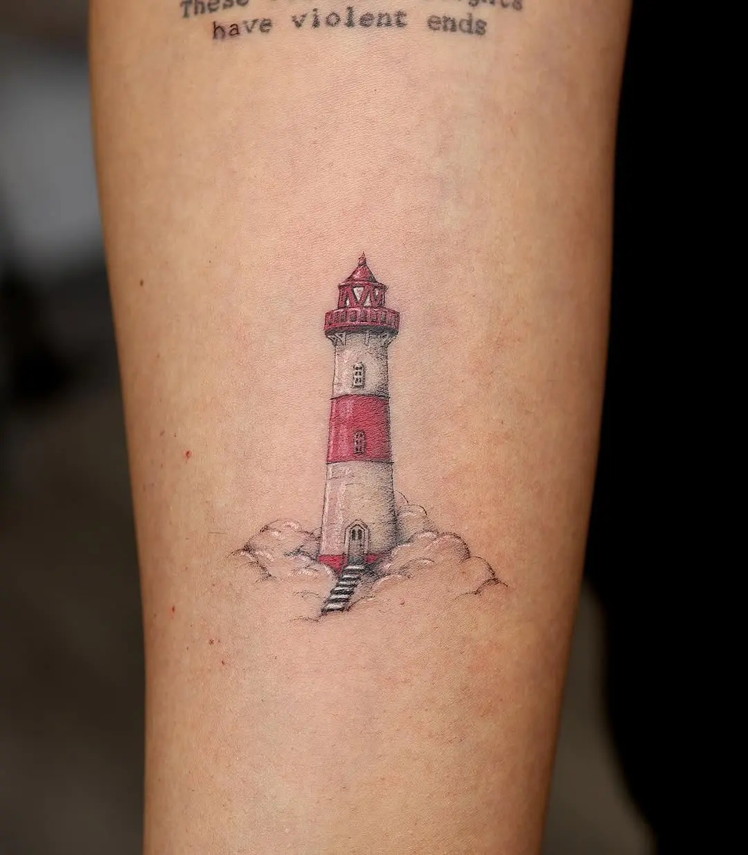 Charming lighthouse tattoo with red and white hues