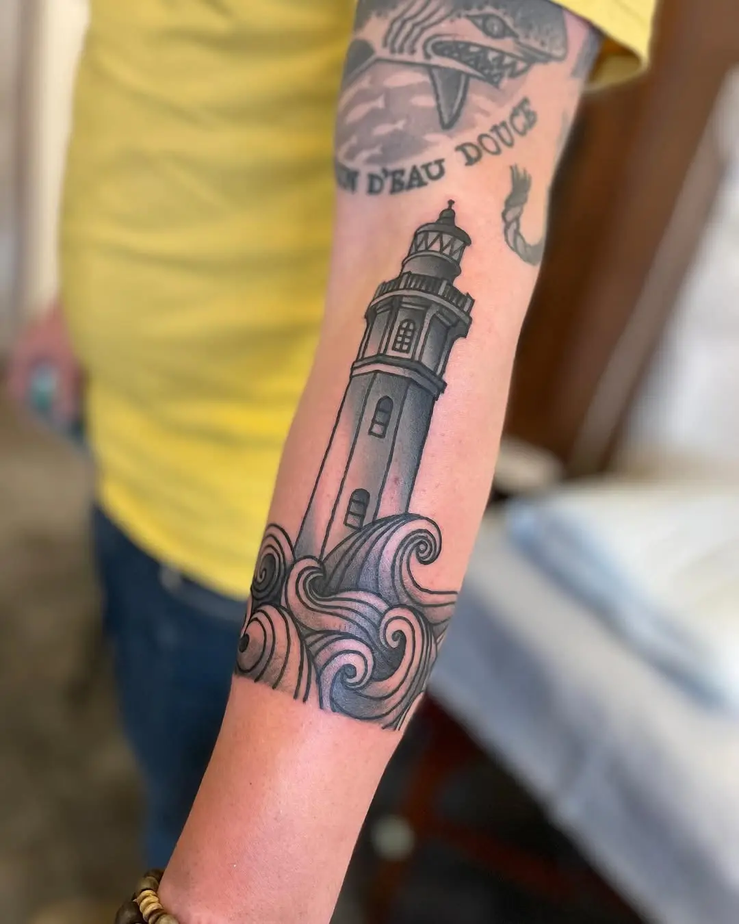Stylized lighthouse amidst swirling ocean waves