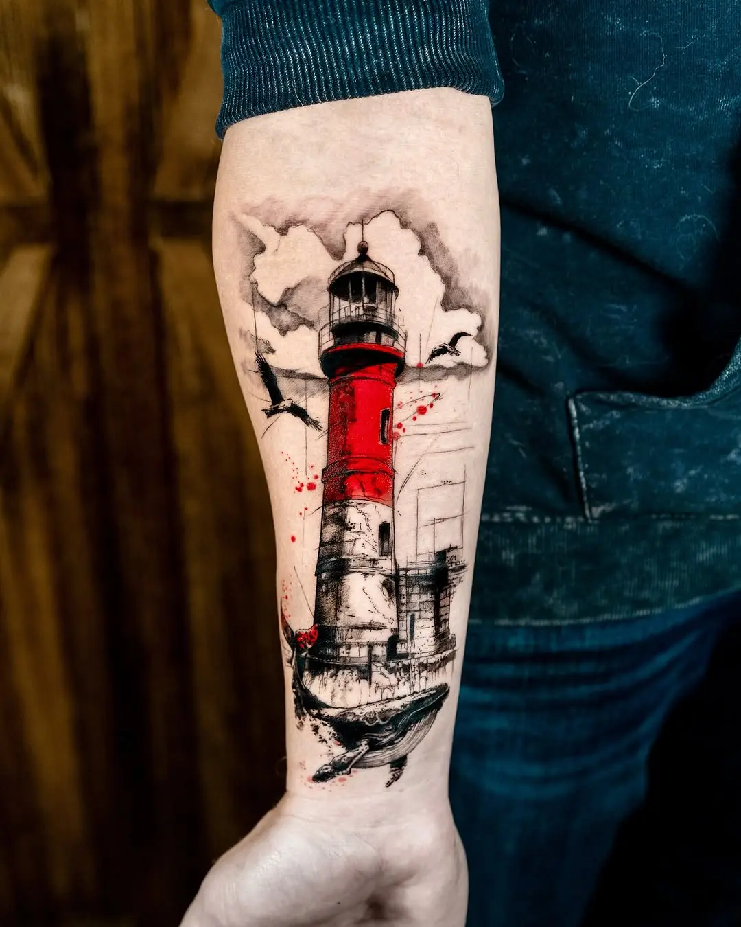Striking lighthouse tattoo with dramatic colors and details
