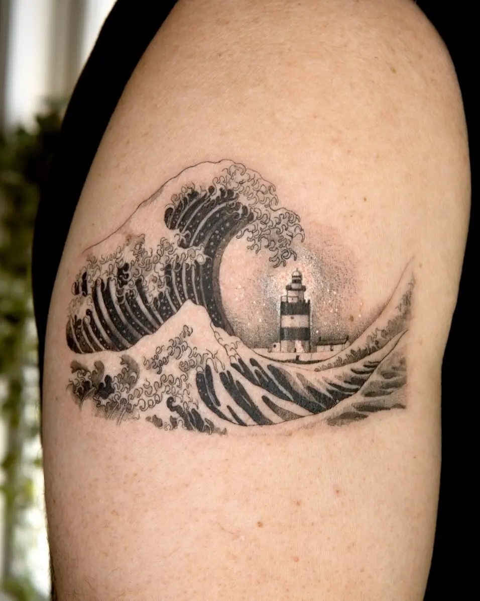 Stunning lighthouse tattoo amidst crashing waves