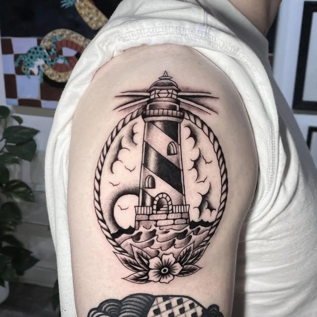 Striking lighthouse tattoo with a nautical vibe