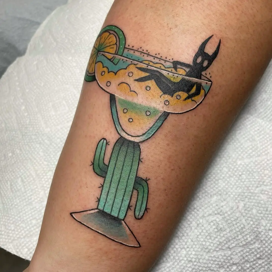 Playful margarita-inspired cactus tattoo design