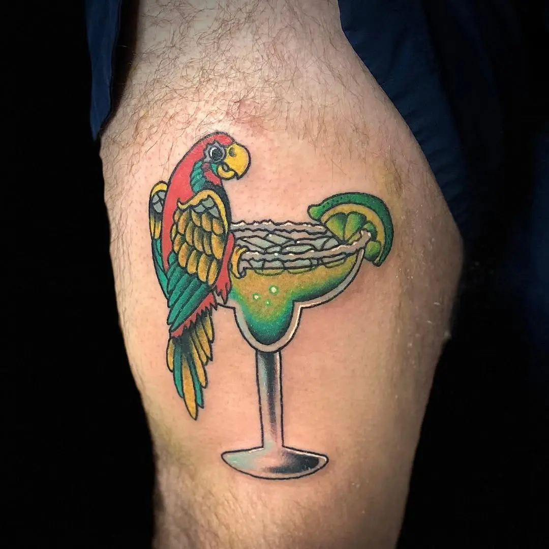 Colorful parrot perched on a margarita glass