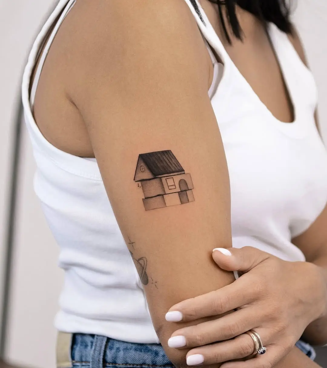 Charming house tattoo on the arm