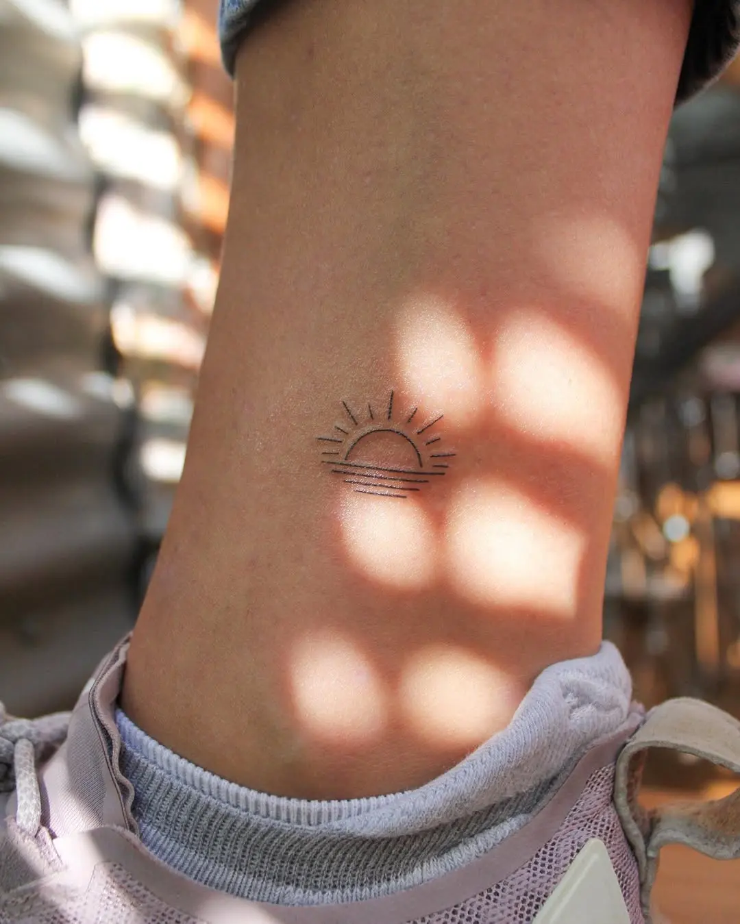 Charming minimalist sunrise tattoo design