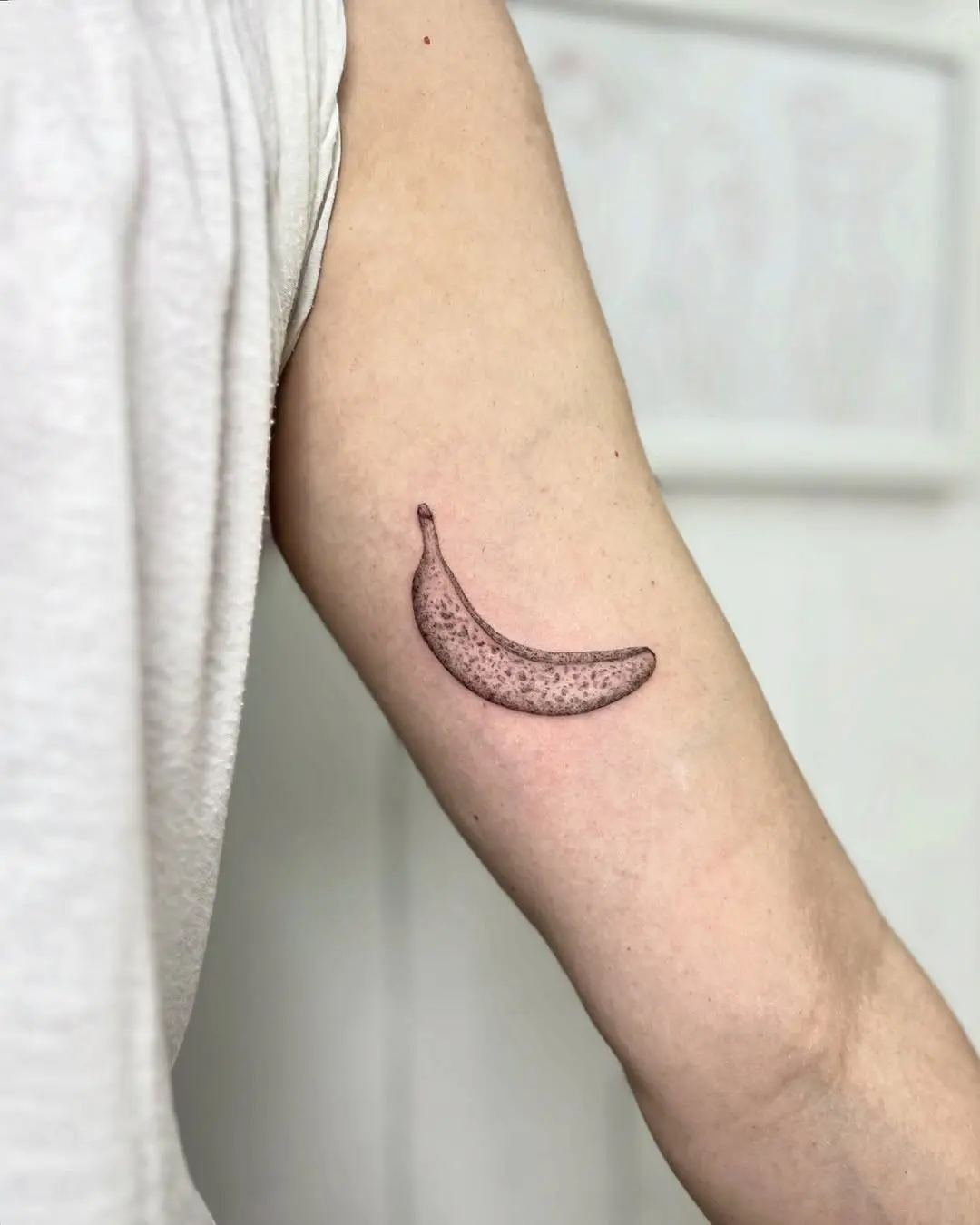 A stylish and minimalistic banana tattoo