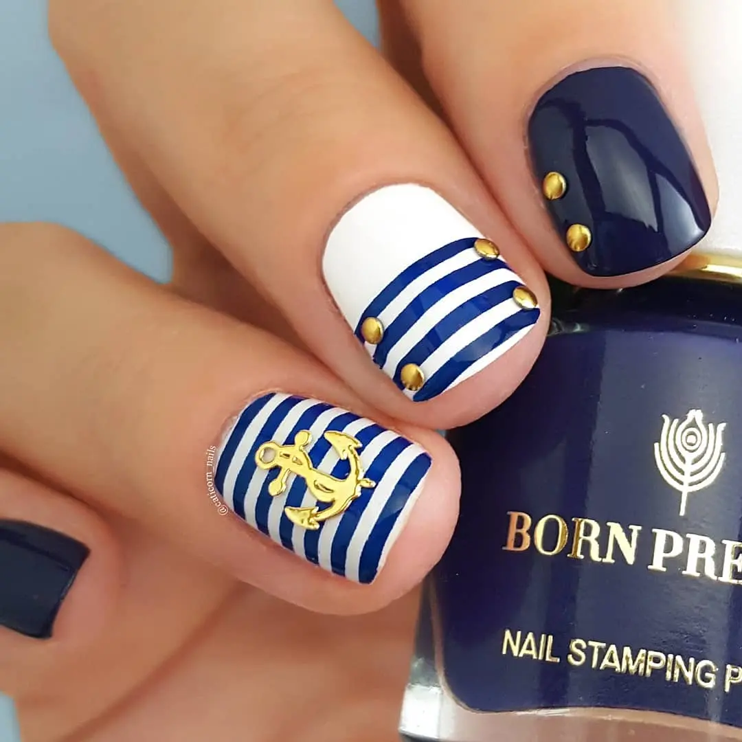 Vibrant nautical nails with chic gold accents