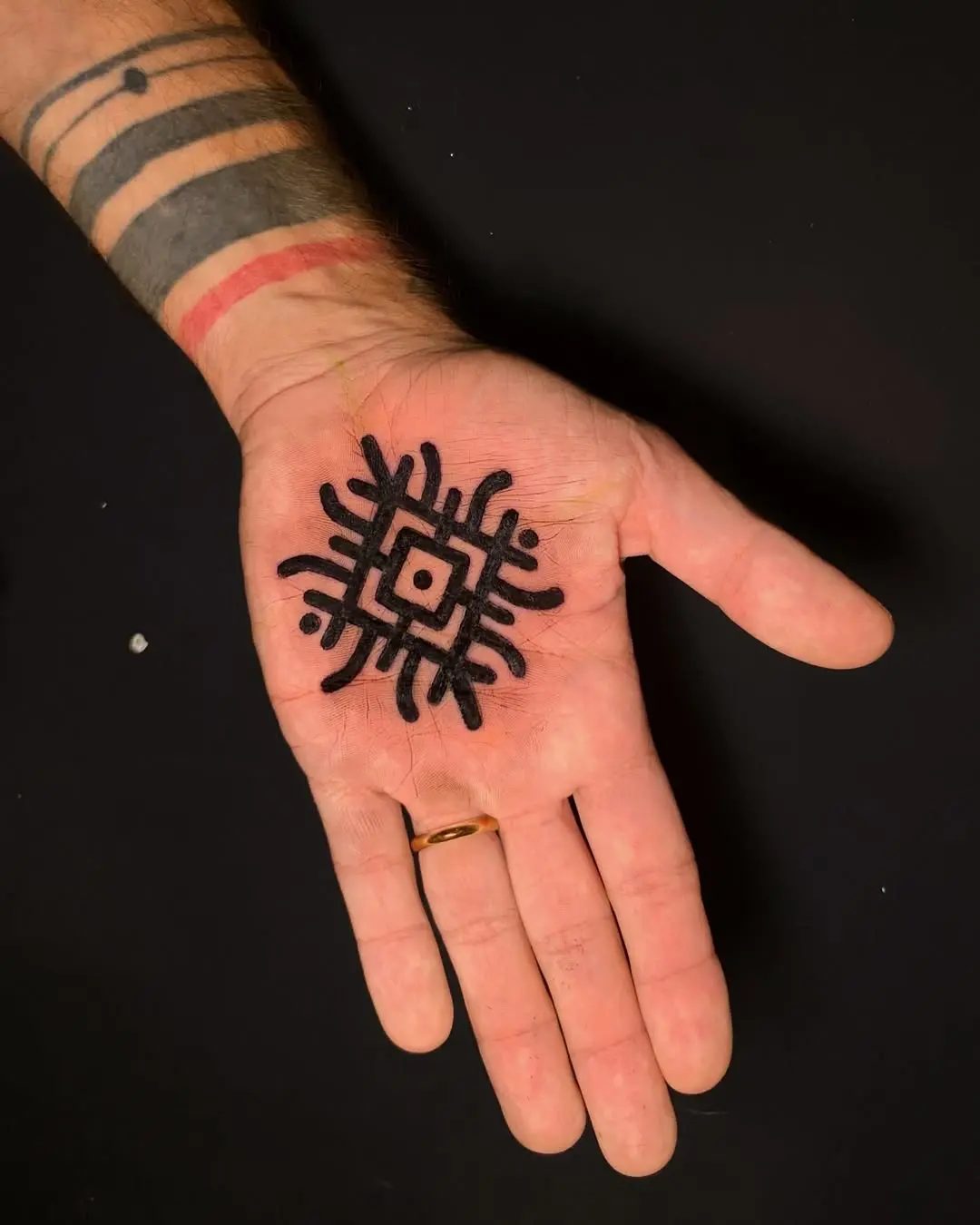 Striking black mandala palm tattoo design