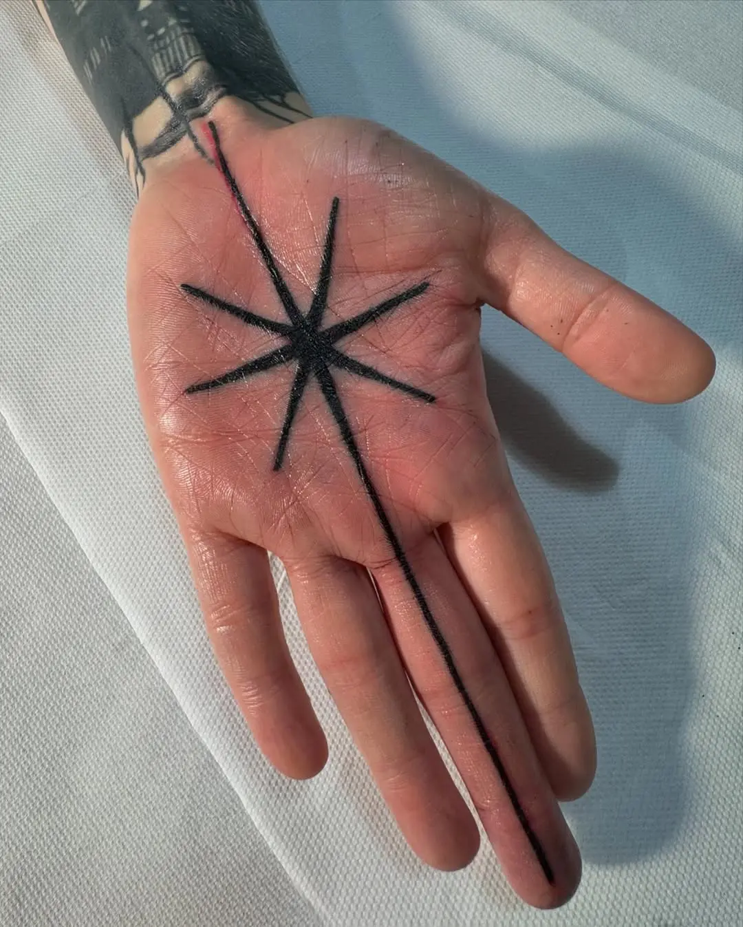 Striking Black Star Palm Tattoo Design