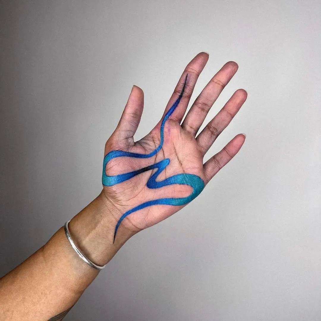 Vibrant blue curves on palm tattoo design