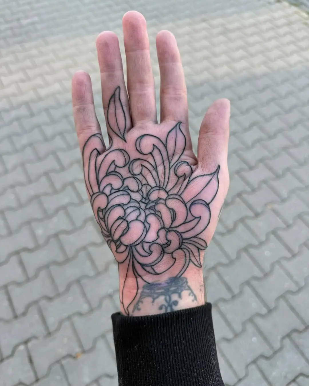 Intricate floral design on palm tattoo