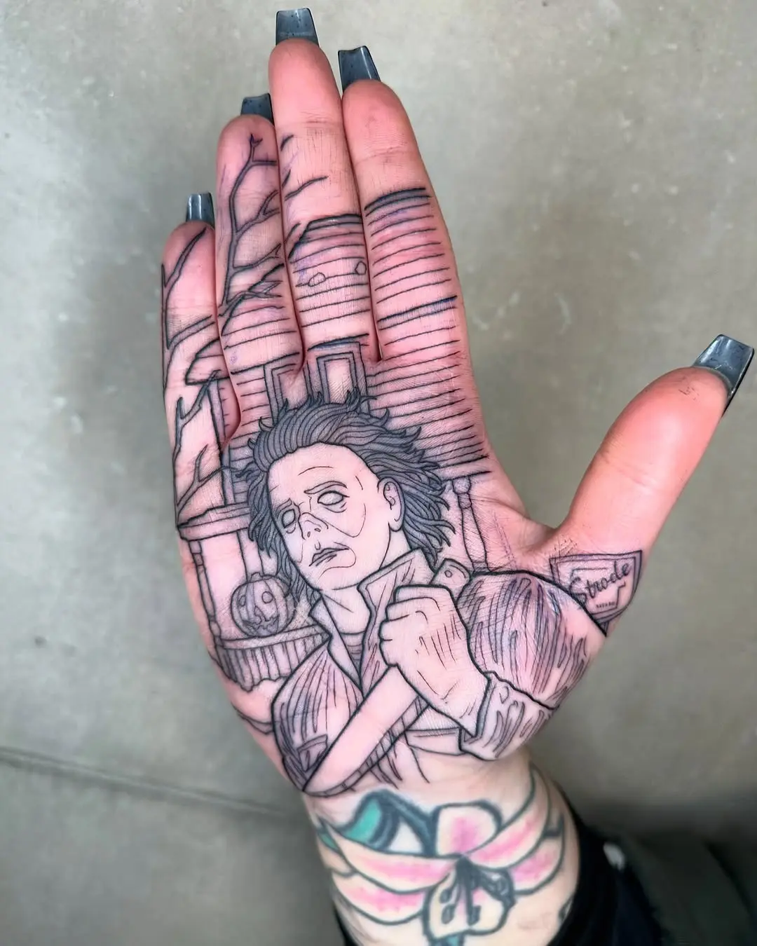 Intricate palm tattoo of horror icon Michael Myers