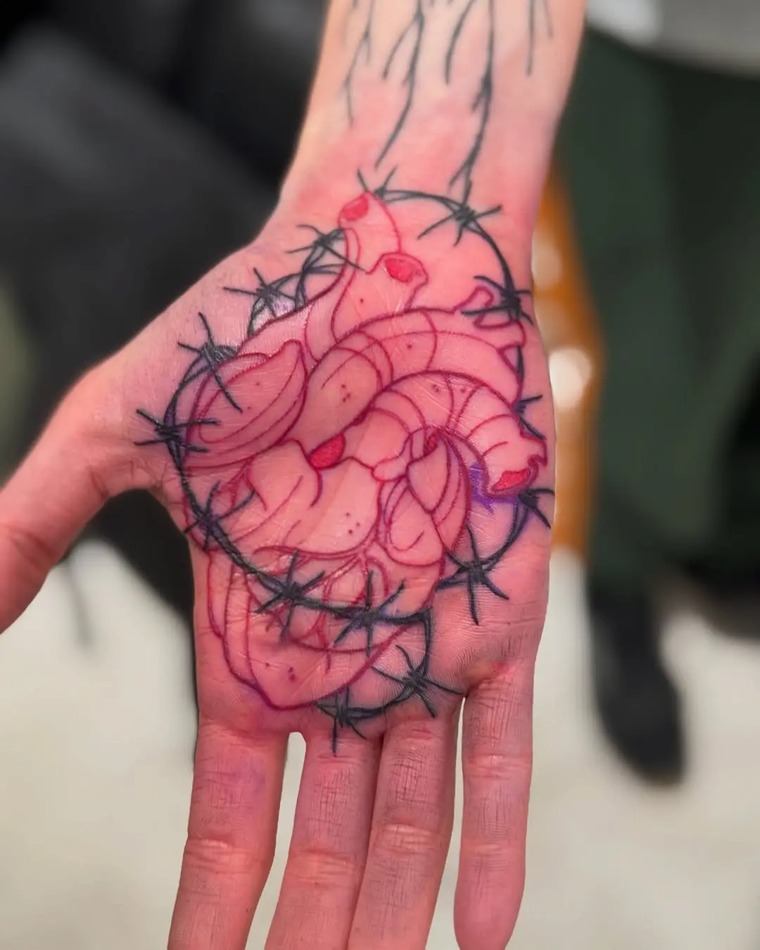 Vibrant palm tattoo of a rose design