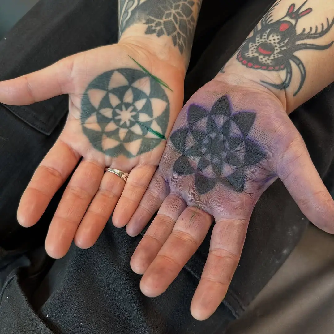 Intricate geometric designs on palm tattoos